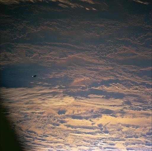 STS088-724-70, 20:18:44 GMT: the object with sunglint behind it