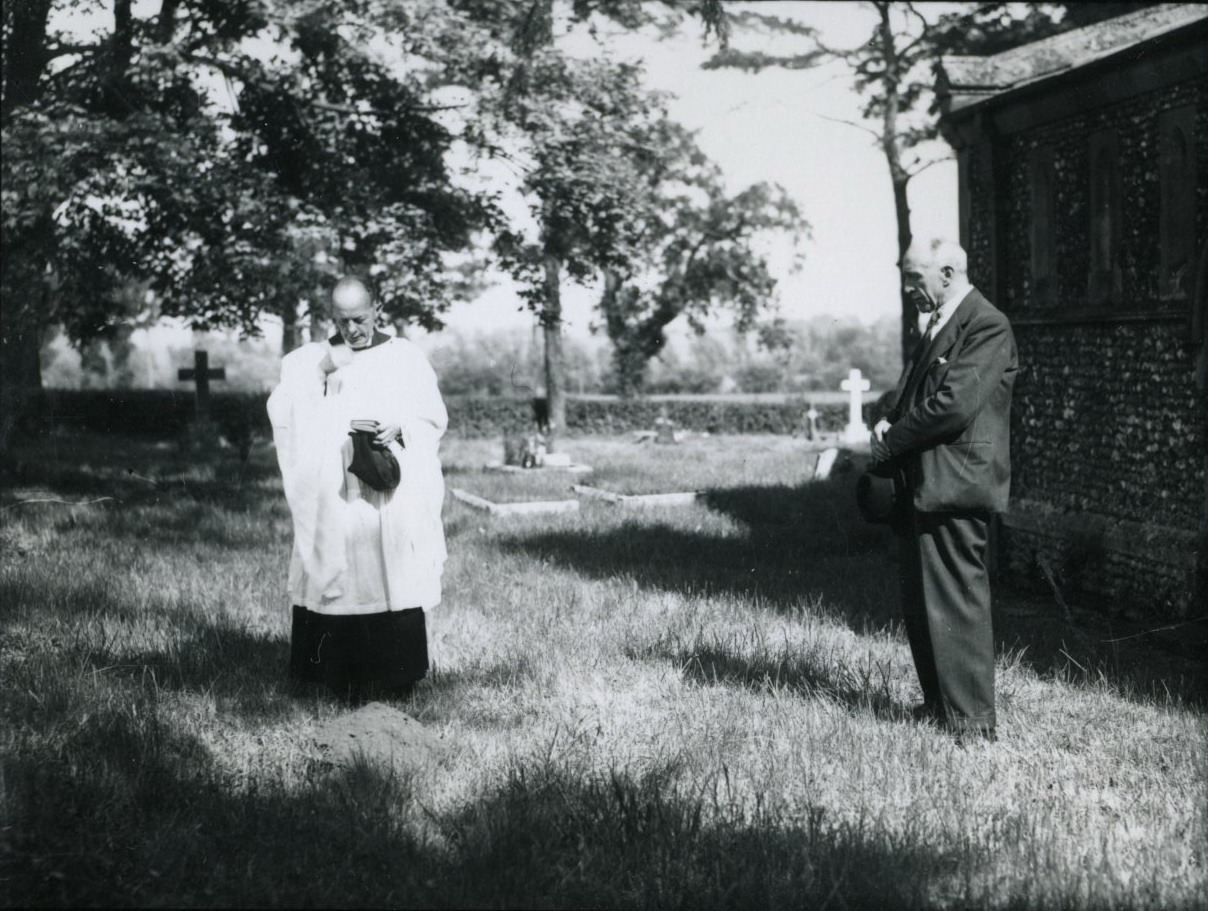 Price and Rev. Henning burying the bones in Liston churchyard.