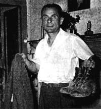 Bruno Facchini holding up the jacket and shoes he wore that night