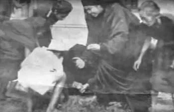 Carmelite nuns stooping to gather petals after a shower.