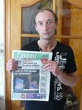 Patrick M. with a newspaper