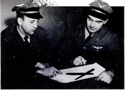 Co-pilot James F. Bachmeier and Captain Lawrence W. Vinther looking at a sketch of the object